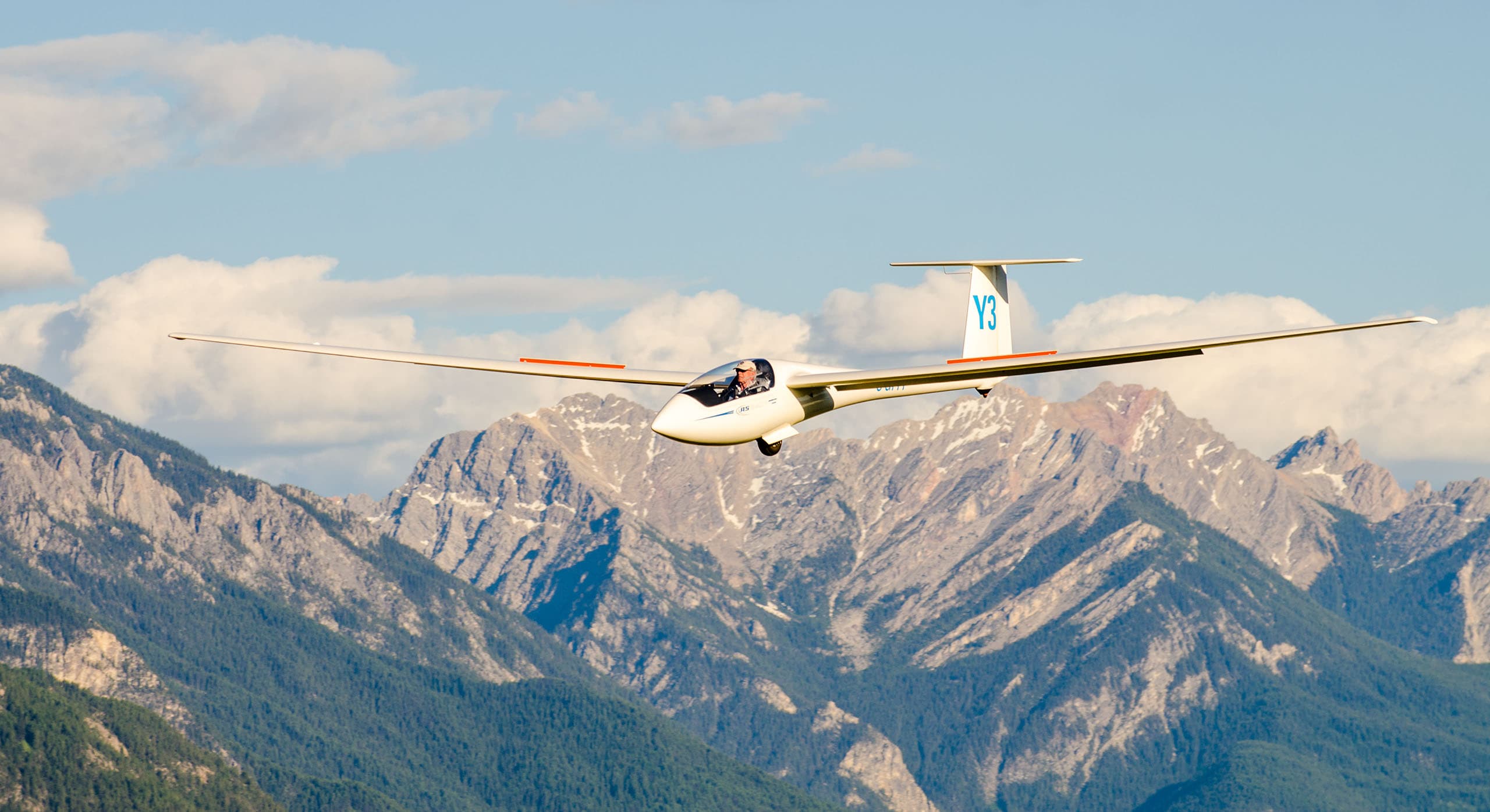 Glider soaring high over the Rocky Mountains