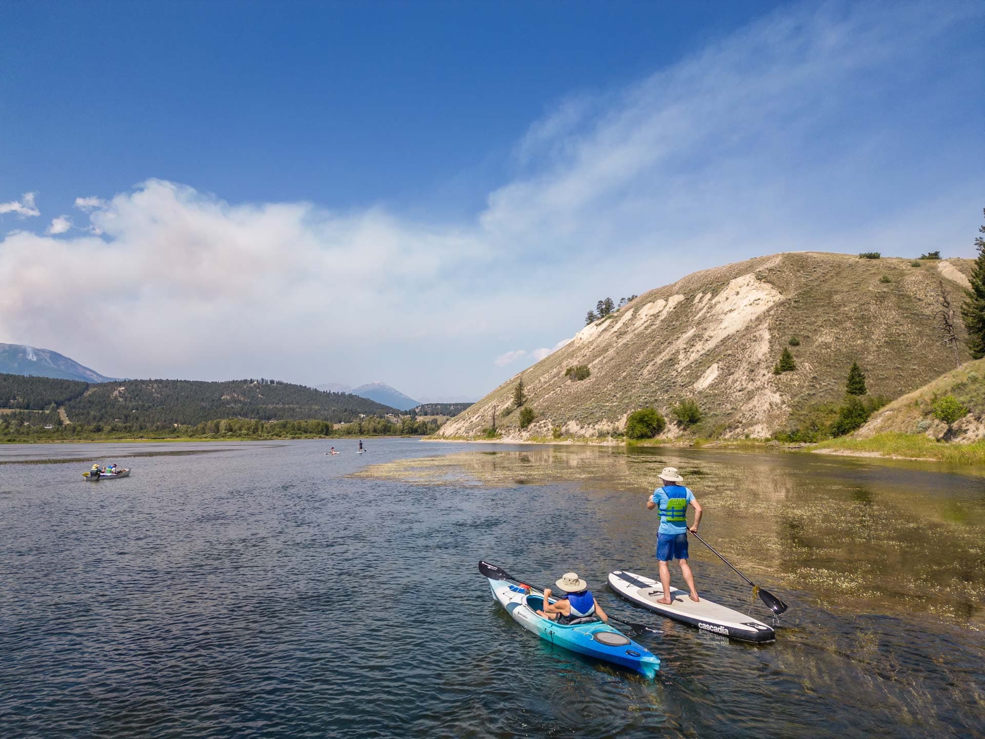 Paddlers on a kayak and paddleboard exploring the Columbia River wetlands